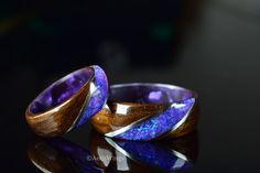 Fumed Eucalyptus wood wrapped around a dark purple epoxy core with an inlay of crushed lavender opal between two bands of Stainless Steel. This ring is handmade from Fumed Eucalyptus wood with good weight and a comfortable fit. The ring is coated with acrylate, making for a waterproof and scratch resistant surface. DETAILS OF THE WOMEN'S WEDDING BAND: Ring Width: 6mm Inlay Opal Color: Lavender DETAILS OF THE MEN'S WEDDING BAND: Ring Width: 8mm Inlay Opal Color: Lavender This rings are made with Purple Wedding Rings, Cool Rings For Men, Lavender Opal, Bentwood Rings, Cute Engagement Rings, Cute Couple Gifts, Eucalyptus Wood, Mens Ring Sizes, Wedding Glasses