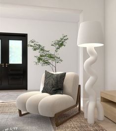 a living room with a chair, lamp and potted plant on the floor in front of it