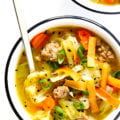 two white bowls filled with soup and vegetables