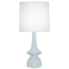 a light blue table lamp with a white shade on the top and bottom part of it