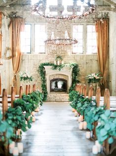 the ceremony room is decorated with candles and greenery