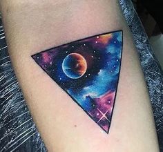 a colorful triangle tattoo on the right arm and shoulder, with planets in the background