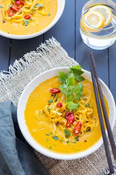 two bowls filled with soup and garnished with cilantro