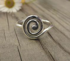 This listing is for a single sterling silver hand made spiral ring. The band of the ring is 1.5mm wide, while the spiral itself is lightly hammered flat and measures 1 cm across. Spirals are one of the oldest symbols found all over the world in ancient art and jewellery, when you see how beautifully it works as a ring, it's easy to see why. These are individually hand forged from sterling silver wire before being hammered and polished to a high shine. As they are forged rather than cast, these r Flo Outfits, Body Decoration, Right Hand Ring, Spiral Ring, Right Hand Rings, Dope Jewelry, Hand Ring, Tiny Stud Earrings, Funky Jewelry