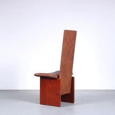 a wooden chair sitting on top of a white floor