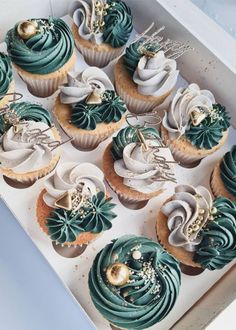 a box filled with cupcakes covered in frosting and decorated with green icing