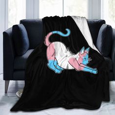 a black couch with a pink and blue cat on it