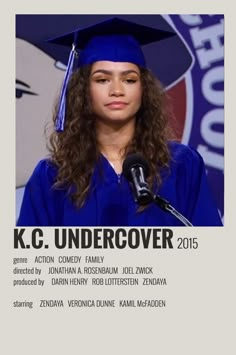 a woman in a graduation cap and gown speaking into a microphone with the words k c undercoverover on it