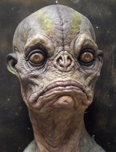 an alien head is shown with yellow eyes and wrinkles on it's face