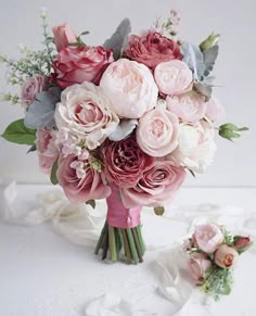 a bridal bouquet with pink and white flowers