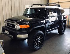 a black and white toyota truck parked in a garage