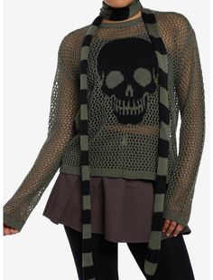 a woman wearing a sweater with a skull on it