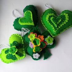 green felt ornaments with flowers and hearts on them