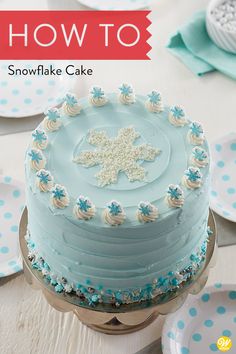 a blue frosted cake sitting on top of a table