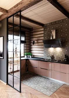 a kitchen with wooden walls and flooring next to an open door that leads into the living room