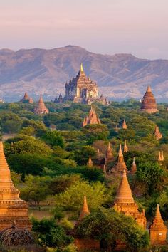 an aerial view of many temples in the distance with mountains in the backgroud