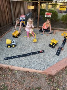 children playing with construction toys in the back yard