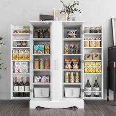 a white pantry with two doors and shelves filled with food, drinks and condiments