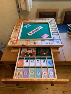 a wooden table topped with lots of different types of game pieces and numbers on it