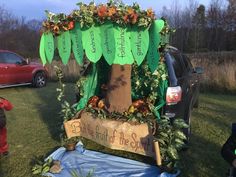 a car is decorated with green leaves and flowers