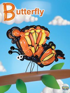 a balloon shaped like a butterfly on top of a tree branch with the words butterfly above it