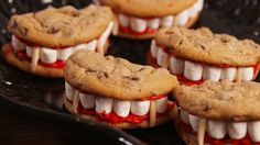 chocolate chip cookies with white marshmallows and red sauce on them are arranged in the shape of teeth