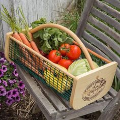 a basket filled with vegetables sitting on top of a wooden bench