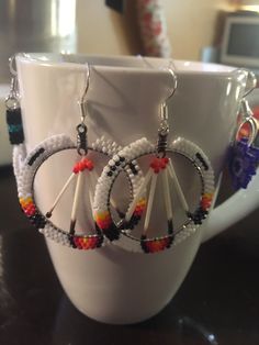 a cup with some kind of earrings on it