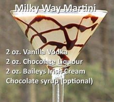 a martini glass filled with liquid and topped with chocolate