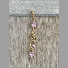 This dangly gold belly button ring features beautiful pink crystals in a long, chandelier shape. Gorgeous option for summer! Drop jaws with this body jewelry. Details & Size: ♥ Surgical Steel ♥ Cubic Zirconia ♥ Nickel Free ♥ 14G, 10mm bar ♥ Every purchase comes with an Elara gift box Please message me if you have any questions We hope you love our jewelry as much as we do! Elegant Gold Belly Rings, Elegant Gold Belly Rings Gift, Elegant 14k Gold Belly Rings For Gift, Elegant 14k Yellow Gold Belly Rings, Dainty Gold Belly Rings For Wedding, Adjustable Gold Belly Rings For Wedding, Gold Belly Button Ring, Cute Septum Rings, Unique Belly Rings