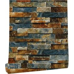 a stone wall with different colors and shapes