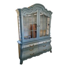 a blue china cabinet with glass doors and drawers