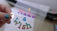 a person holding a piece of paper with the words make a wish on it