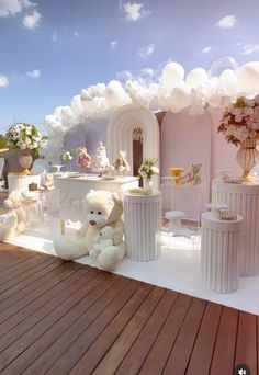 there is a teddy bear sitting in front of a fake wedding set on the deck