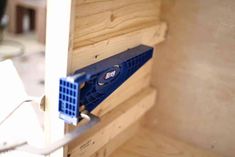 a blue fan sitting on top of a wooden shelf