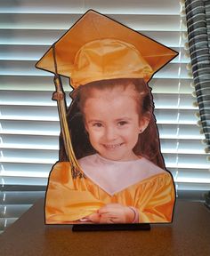 a child's graduation cap and gown is placed on a desk