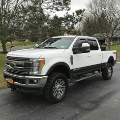 a white truck is parked on the street