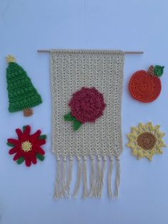 an image of a knitted wall hanging with flowers and poinsettis