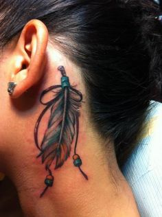 a woman with a tattoo on her neck and behind the ear is a small feather