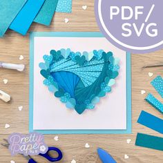 a heart shaped card surrounded by crafting supplies and scissors on a table with the words pretty paper designs