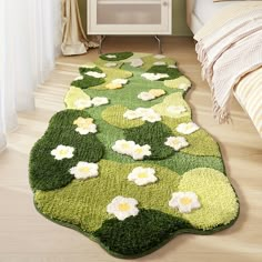 a green rug with white flowers on it