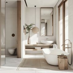 a white bathtub sitting next to a sink in a bathroom under a large mirror