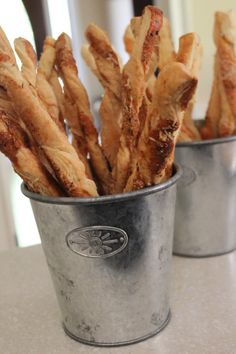 two buckets filled with french fries sitting on top of a table