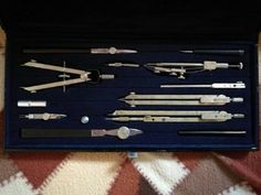 an assortment of knives and spoons in a case