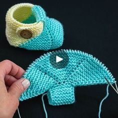 someone crocheting an elephant hat and booties together