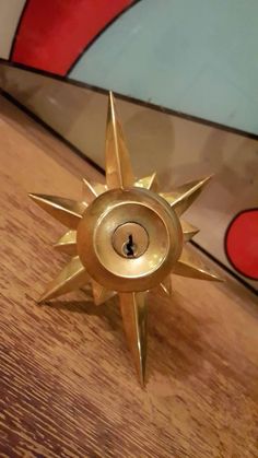 a brass sunburst on a wooden table