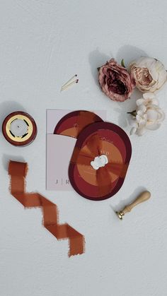 the contents of an apple product are laid out on a white surface with flowers and scissors