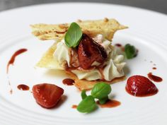 a white plate topped with food and garnish