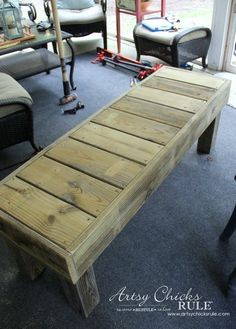 a wooden bench sitting on top of a blue carpeted floor