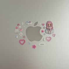 an apple sticker on the side of a white laptop with pink and silver hearts